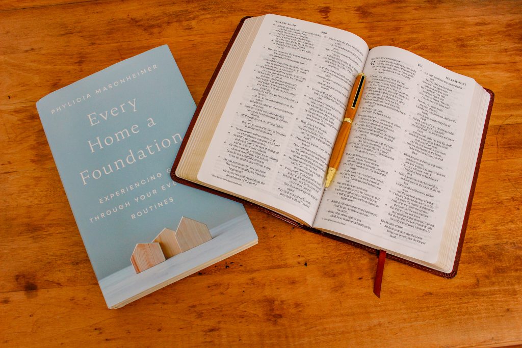 A Bible sits open on top of the book "Every Home a Foundation" by Phylicia Masonheimer.