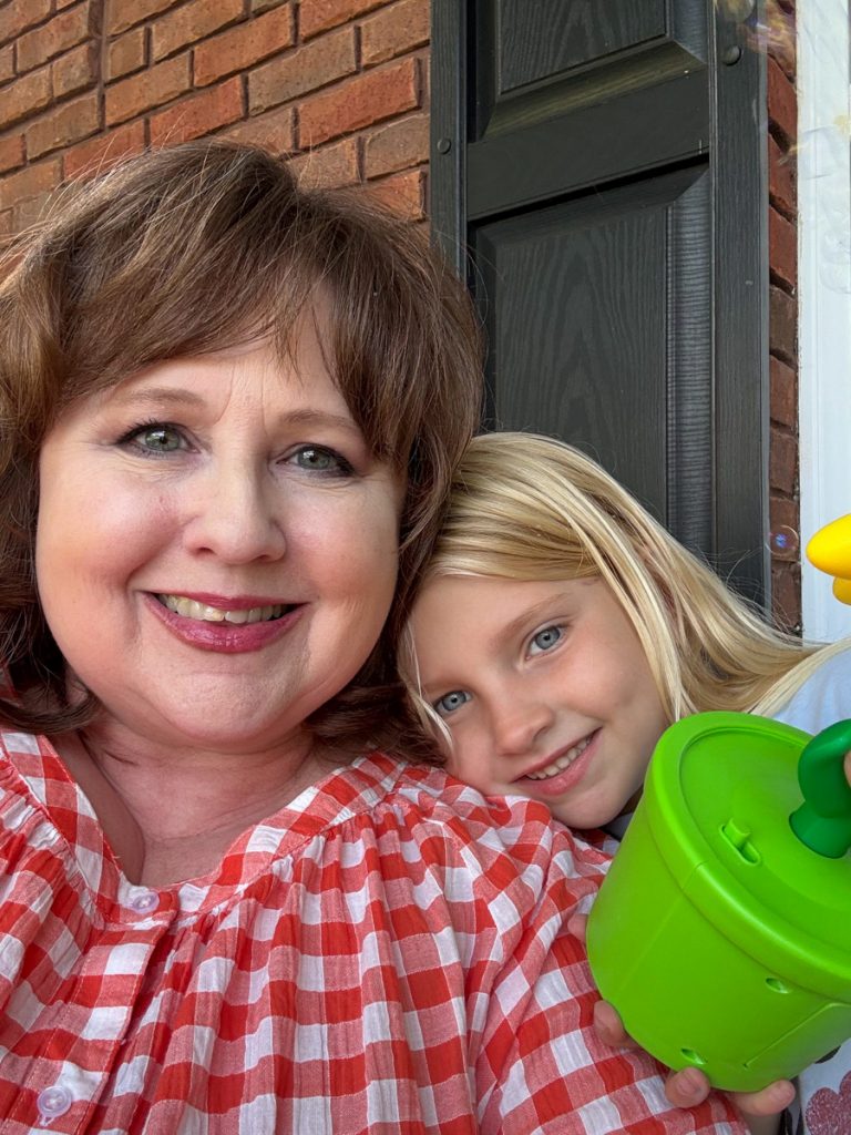 A grandmother and granddaughter share a cuddle.