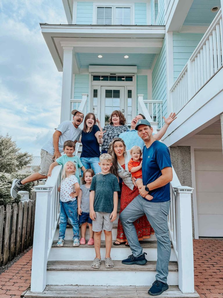 A family poses on the steps of their vacation cottage