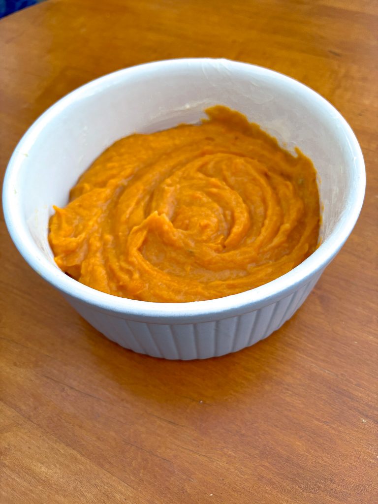 The sweet potato casserole mixture has just been put into a casserole dish.