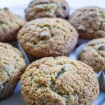 Muffins are arranged on a white plate, waiting to be eaten.